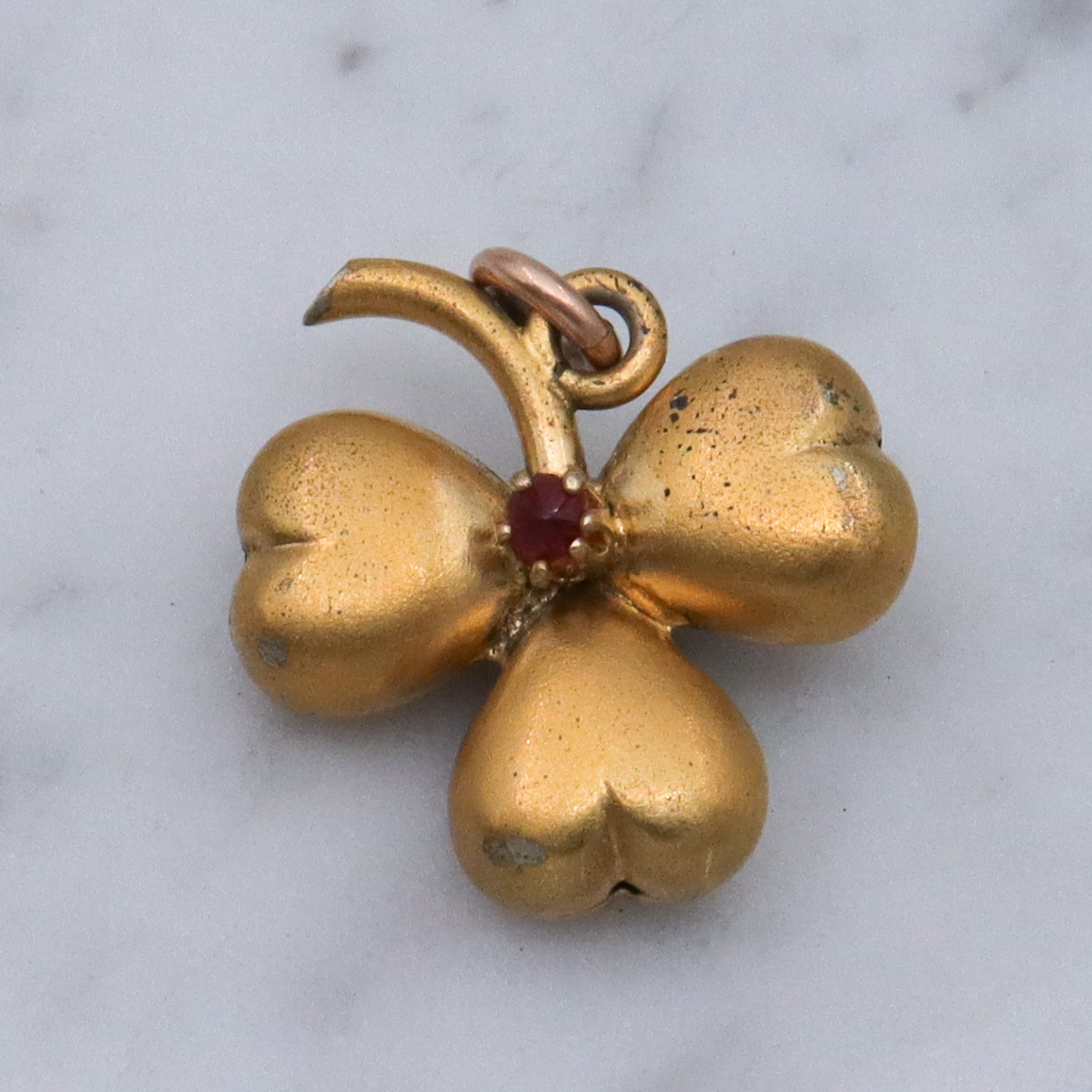 Antique Victorian gilt metal clover with faux garnet pendant